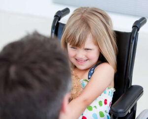 Reserved little girl with hemiplagia sitting on wheelchair