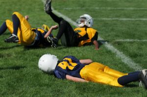Player lying on a field with a concussion
