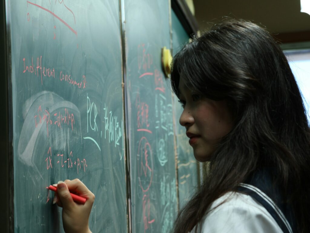 Child writing on blackboard