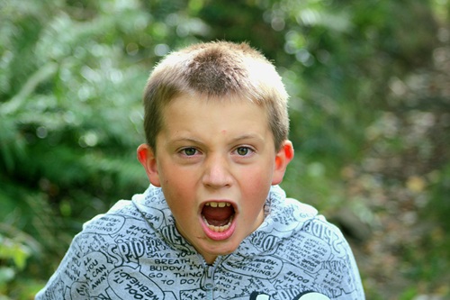 Child standing yelling into the air